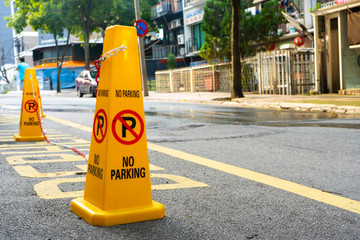 Plastic yellow cones forbidding parking nearby. close up