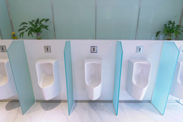A neat row of male urinary slot

