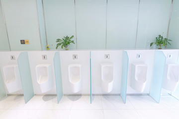 A neat row of male urinary slot
