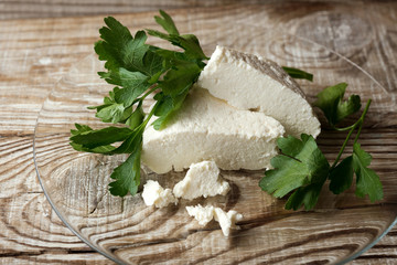 homemade Adyghe cheese on a wooden background