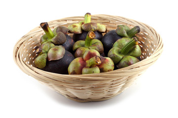 Mangosteen fruits on wicker plate