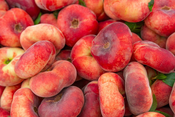 Flat nectarine, donut saturn peach at street fruit vegetables market, ecological organic food from local producers