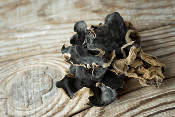 Dry Chinese black muer mushroom on a wooden background