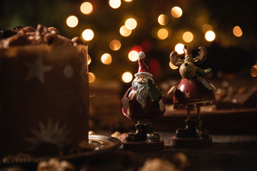Product photography of Christmas bread with walnuts and almonds , decorated with christmas figures. 
Christmas lights bokeh background.