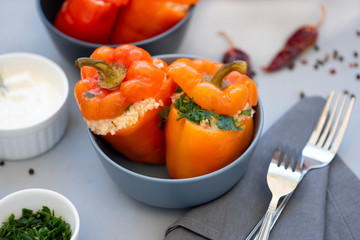 Red pepper stuffed with meat, rice and vegetables on gray background.  Healthy food or vegetarian concept. Selective focus