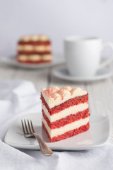 Red Velvet cake slice and a cup of coffee. white background.