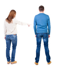 Back view of couple in sweater pointing.