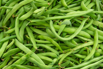 Pile of green beans, Haricots Verts at local producers street fruit and vegetables market, organic ecological food