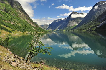 Reflection of mountains in the water of the Norwegian fjord.