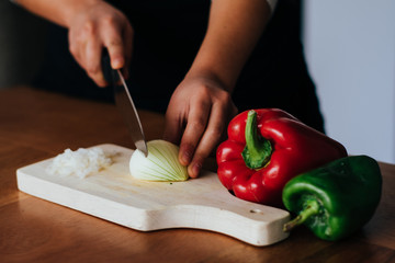 woman cutting vegetables on the kitchen