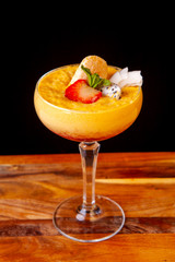 alcoholic dessert in a glass decorated with fruits in the studio