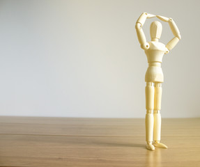 COVID-19 Pandemic Coronavirus and business concept. Wooden model of a man in warm sunlight. Space for your inscription.