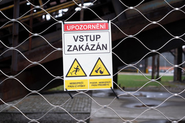 Warning sign with text (translation from czech language: Caution: No Admittance). Blurred old...