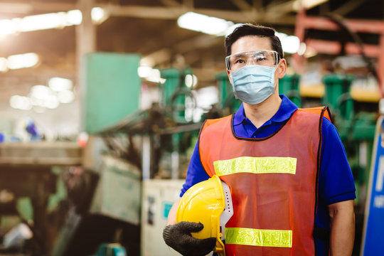 Asian Worker wear disposable face mask for protection Corona Virus Spreading and Smoke dust air pollution filter in factory for healthy labor care.