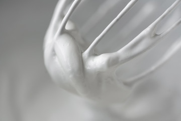 Close up shoot of whisk in cream