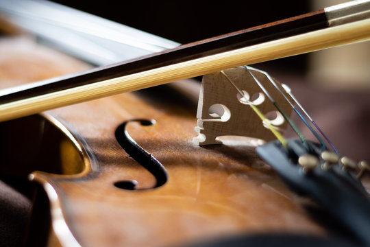 Artful close-up photo of a violin body and bow