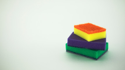 multi-colored dish washing sponges on a white background