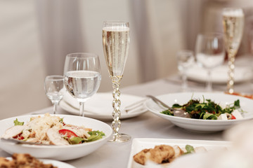 Serving table of a variety of delicious festive food and wine prepared for event party or wedding. selective focus.