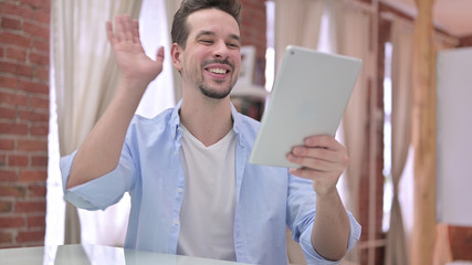 Young Man doing Video Chat on Tablet