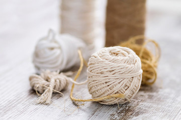 Rope balls of different types over a wooden background