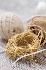 Rope balls of different types over a wooden background