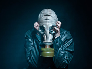 Men with a vintage mask gas and leather coat