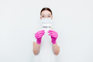 Coronavirus concept. Close up of doctor hands holding paper with coronavirus text written on it. Coronavirus concept responsible for flu outbreak and coronaviruses influenza. Impact of pandemic virus.