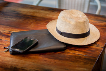 cell phone with hat on a wooden table