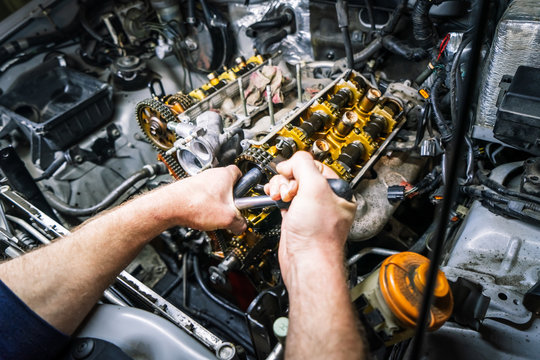 Car repair: overhaul of the V6 engine with detailed pulleys and parts.