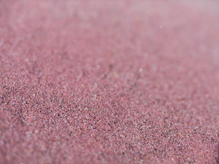 Pink sand on the lake shore. Sandy pink beach