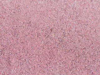 Pink sand on the lake shore. Sandy pink beach