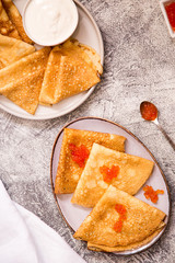 Traditional Russian pancakes with red caviar. Fried crepes with caviar and sour cream