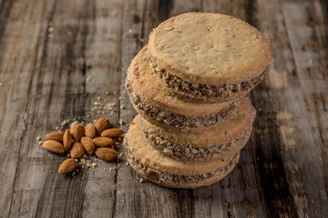 cornstarch alfajor with dulce de leche and homemade coconut in squares on wood