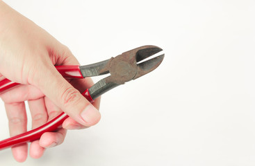 Hand of man holding pliers cutting. on white background
