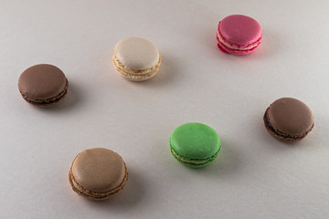 colored macaroon cakes on a light background, pattern