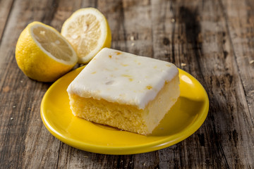 homemade lemon cake in squares on wood