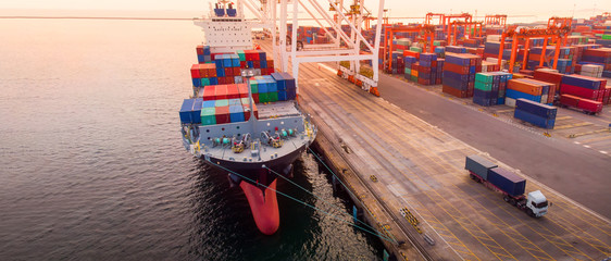 crane loanding cargo container to container ship in the international terminal yard port  concept...