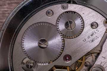 Old watch mechanism with deatil of precision cog wheels and jewels