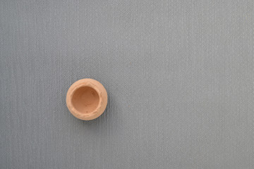 piece of red pottery clay on grey backround. Close up. No people. Top view. Flat lay. Copy space