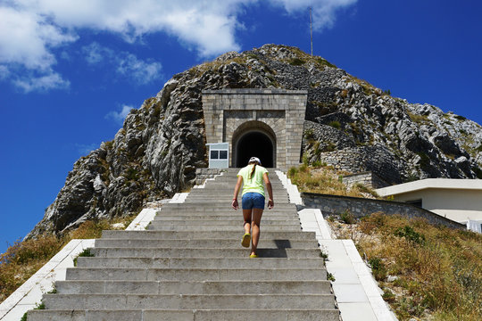 Tired Girl With Her Head Down Rises Up A Large Long Staircase To The Top Of The Mountain And The Tower, Overcoming Of Difficulties, Way Up To Goals             