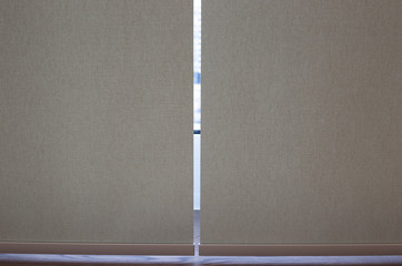 Roller blinds closeup on the window. Selective fokus. Motorized roller shades. Beige color, texture...