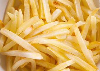 French fries texture as a background. Closeup of tasty french fries with salt. Top view