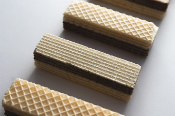 crispy waffle with cream and chocolate filling on a white background