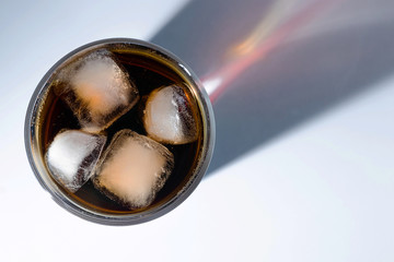 whiskey cocktail with cola and ice in a transparent glass