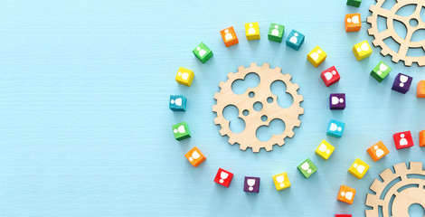 image of colorful blocks with people icons over wooden table ,human resources and management concept