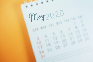 May calender 2020 on orange background with selective focus.  