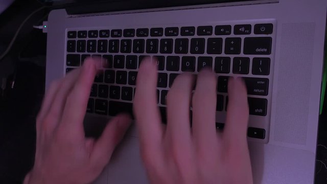 Male Hands typing with Writers block from lateral view with slow shutter speed 4K