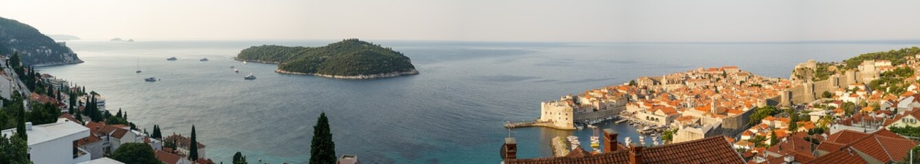 Large panorama of the city of Dubrovnik: southeast, Lokrum island, an old fortress, lit by the rising sun