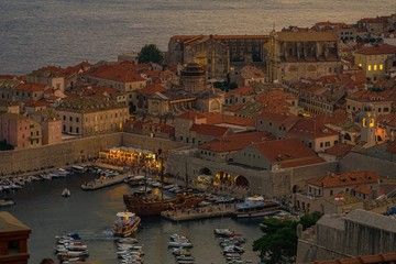 The dying rays of the setting sun gilded the sea and the old city, lights came on