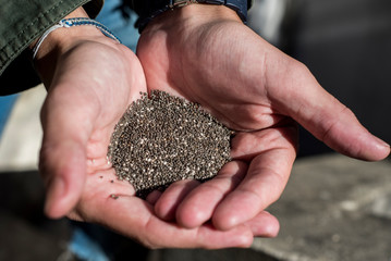 young woman with chia seeds in her hands showing the current trend towards a healthy and balanced organic diet